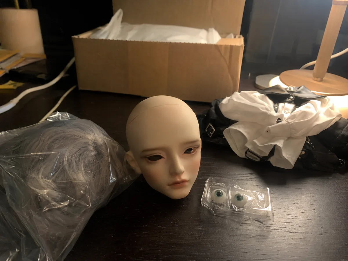 Desk lamp arrival check: A casual night-time desk photo showing the received head and accessories under normal room light.